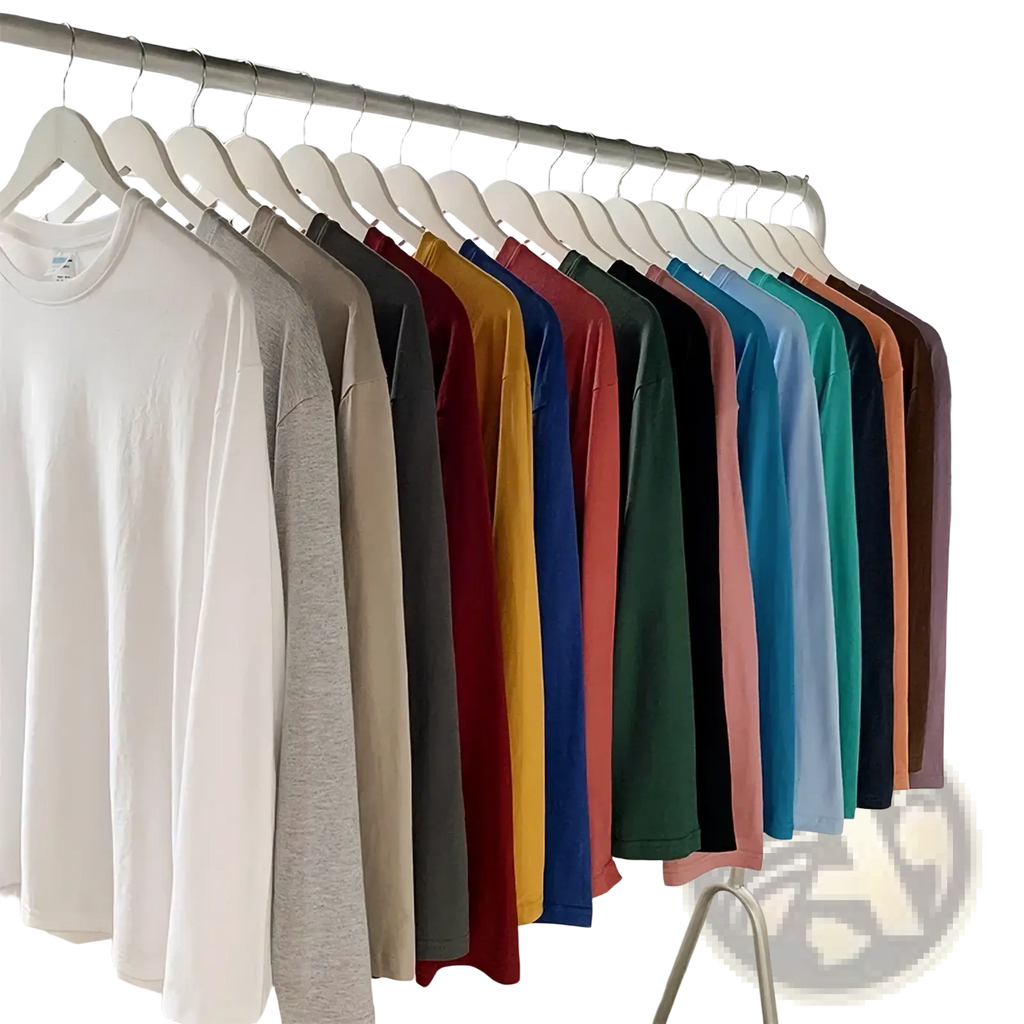 A row of oversized long sleeve blank t shirts in 48 solid colors neatly hung on white hangers