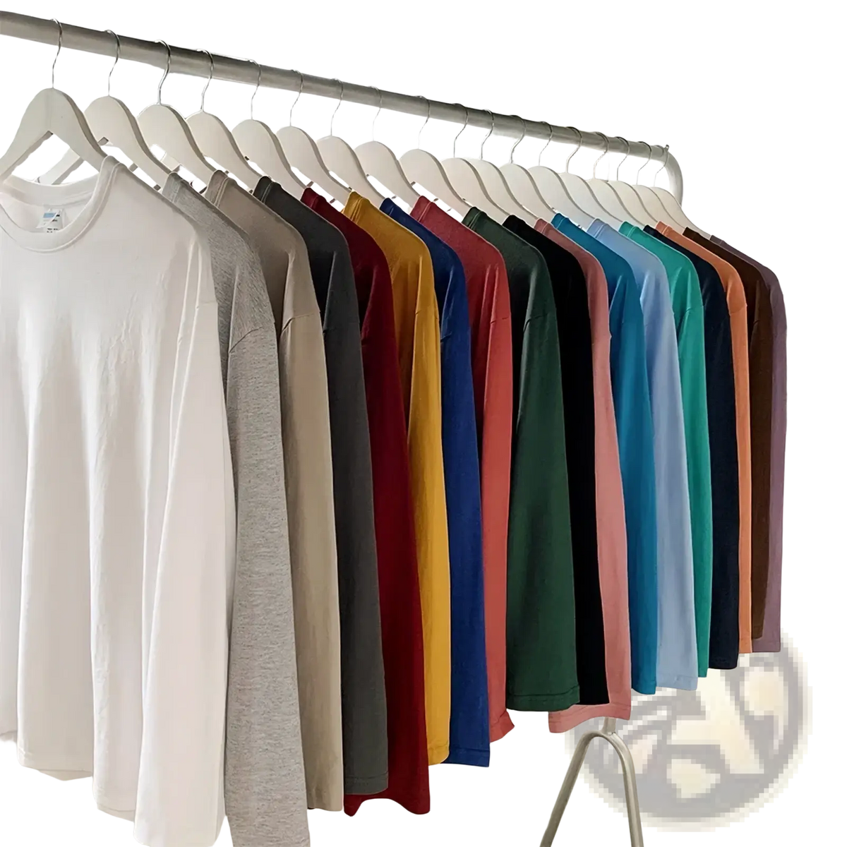 A row of oversized long sleeve blank t shirts in 48 solid colors neatly hung on white hangers