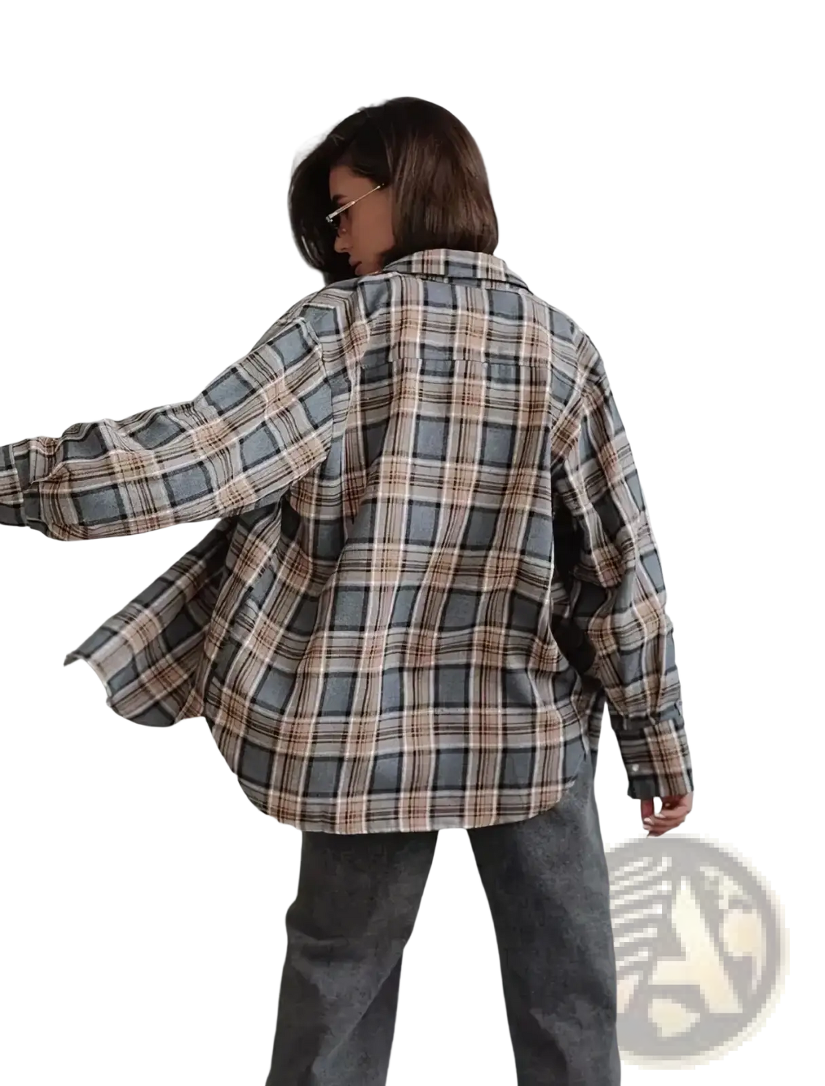 A woman wears an oversized plaid flannel shirt with gray and beige stripes casual outerwear made of soft fabric