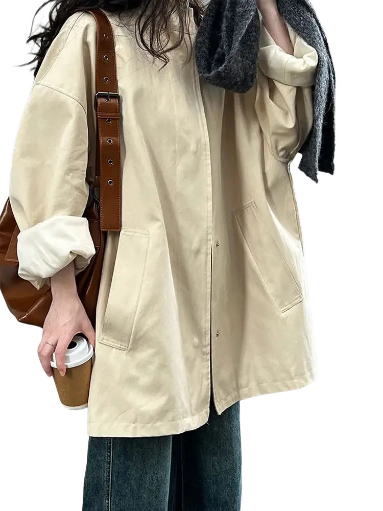 Beige oversized single breasted trench coat for women with button closures and front pockets in a lightweight fabric