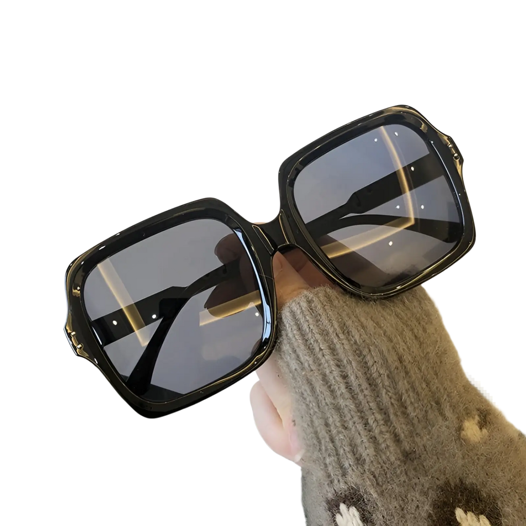 Oversized square fashion sunglasses with black glossy frames and dark gray lenses for stylish sun protection