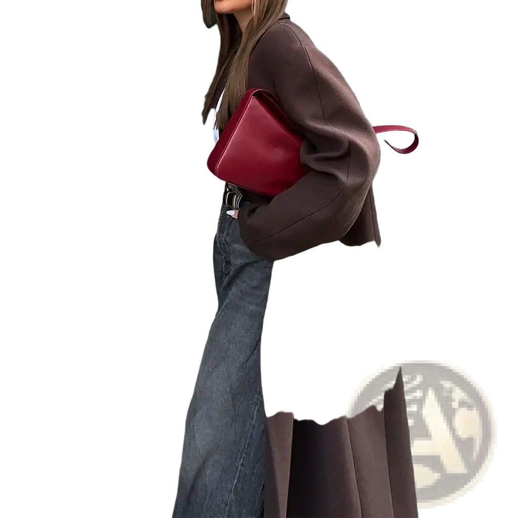 A sleek vibrant red leather crossbody bag with minimalist design and matching strap for stylish fall outfits