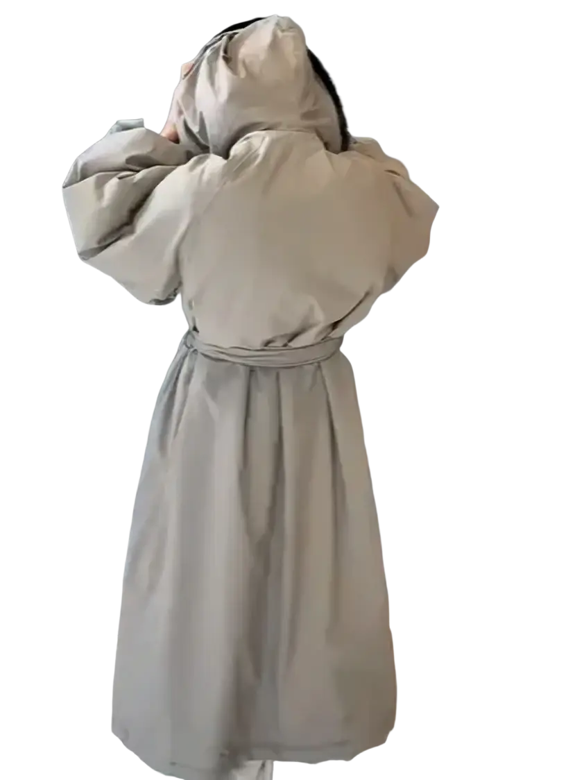 Beige oversized trench coat with hood and cinched waist in warm puffer material for winter outerwear use