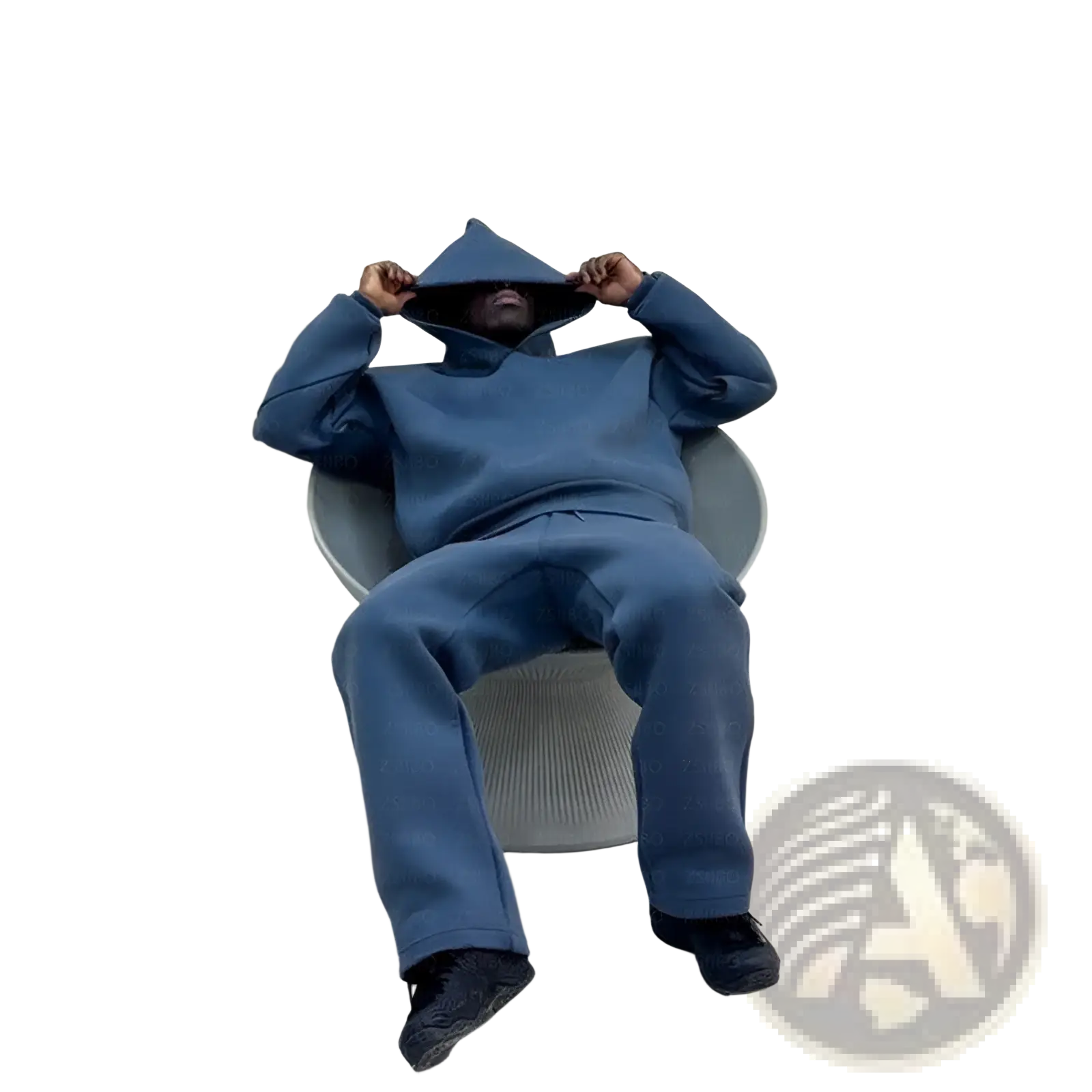 A person wearing a navy blue oversized unisex streetwear hoodie and sweatpants set seated in a modern gray chair