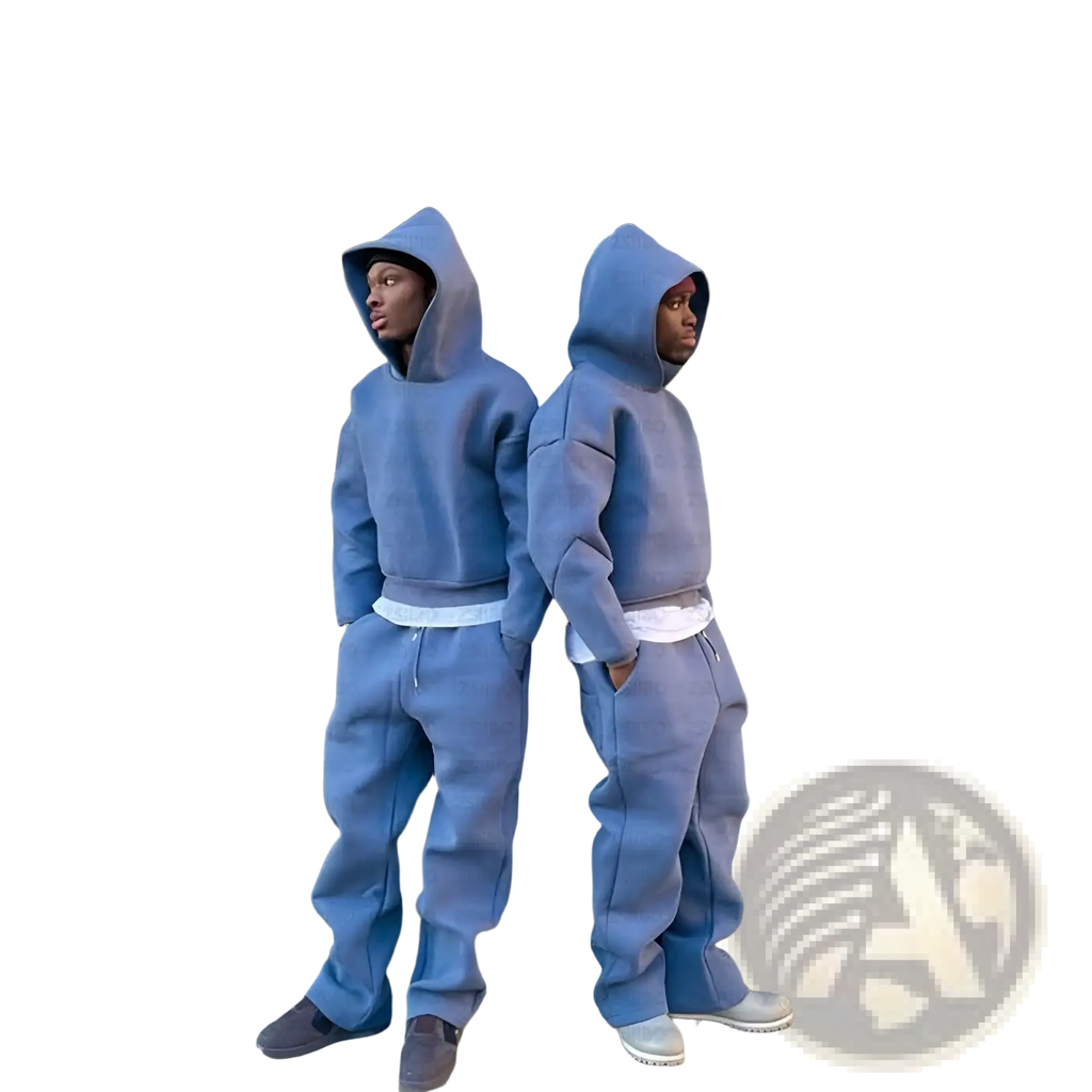 Two individuals wear matching oversized unisex slate blue streetwear hoodie and jogger sets with white waistbands