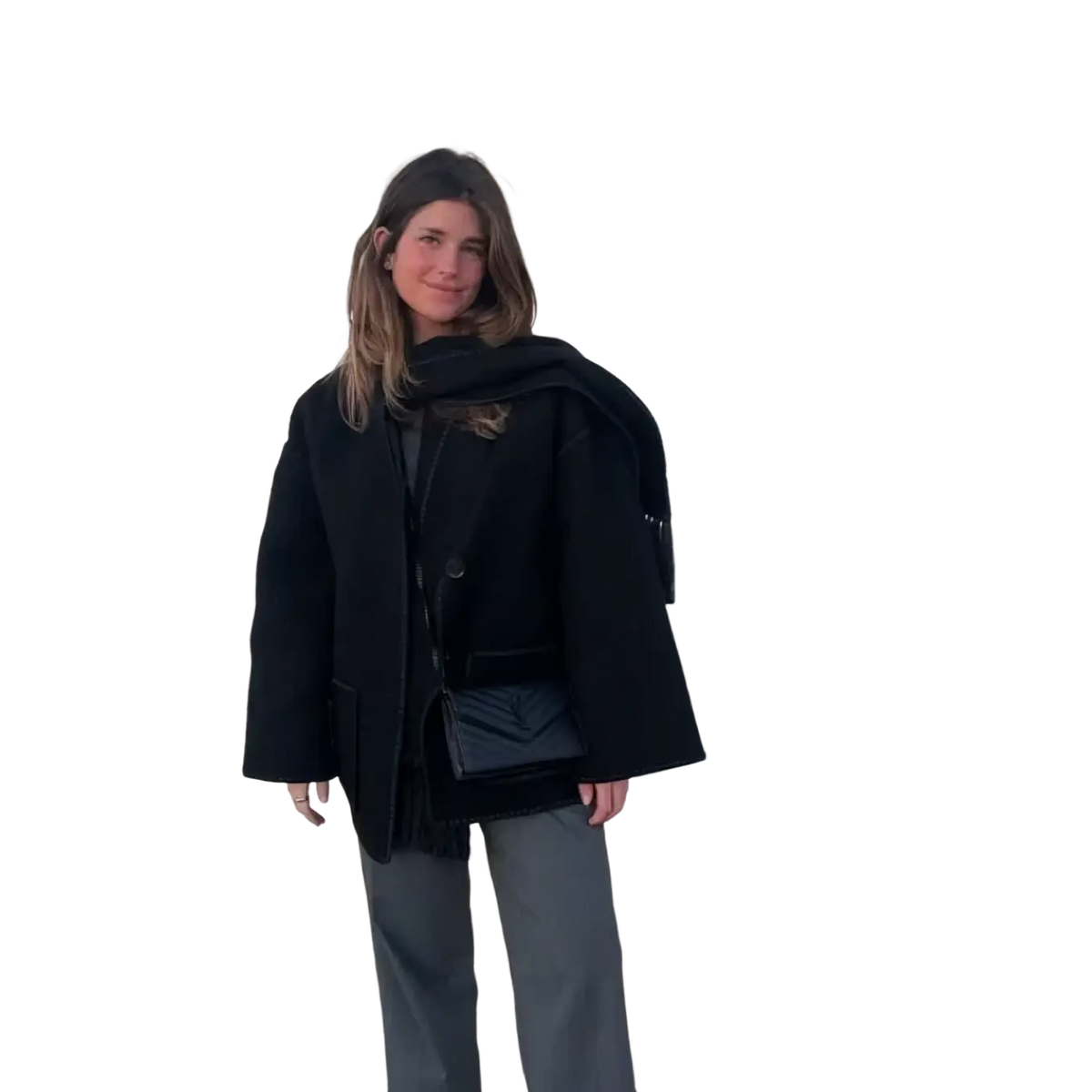 Black quilted crossbody bag with sleek minimalist design and subtle stitching paired with oversized wool blend coat with contrast trim
