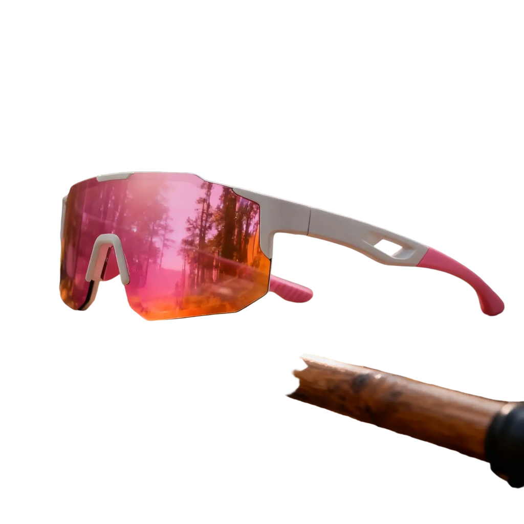 Pink and white oversized wraparound sports sunglasses with uv400 reflective lenses resting on wooden stick in forest