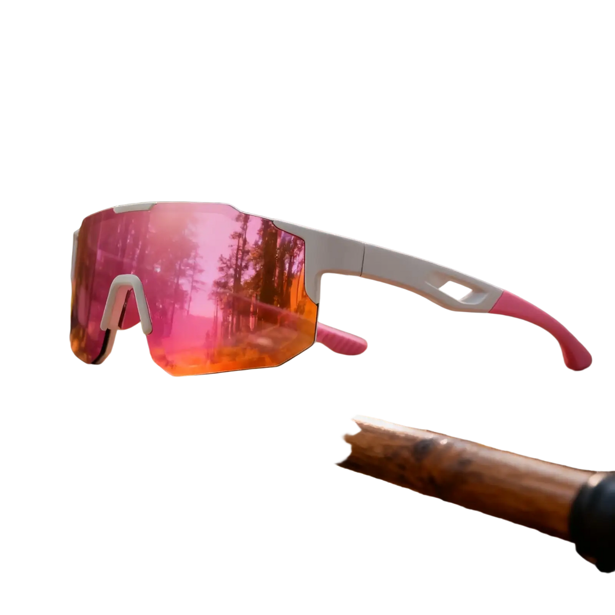 Pink and white oversized wraparound sports sunglasses with uv400 reflective lenses resting on wooden stick in forest
