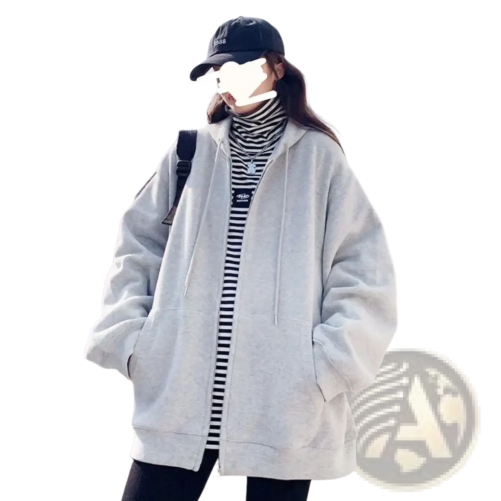 Light gray oversized zip up hoodie with drawstring hood and fleece material worn over black and white striped turtleneck