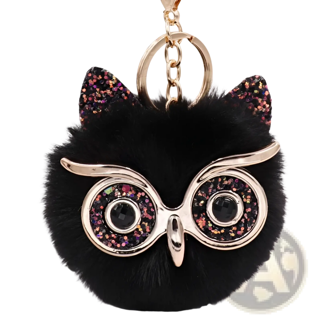 Black fluffy owl plush keychain with glittery pink and gold ears and shiny black gemstone eyes round glasses
