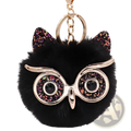 Black fluffy owl plush keychain with glittery pink and gold ears and shiny black gemstone eyes round glasses