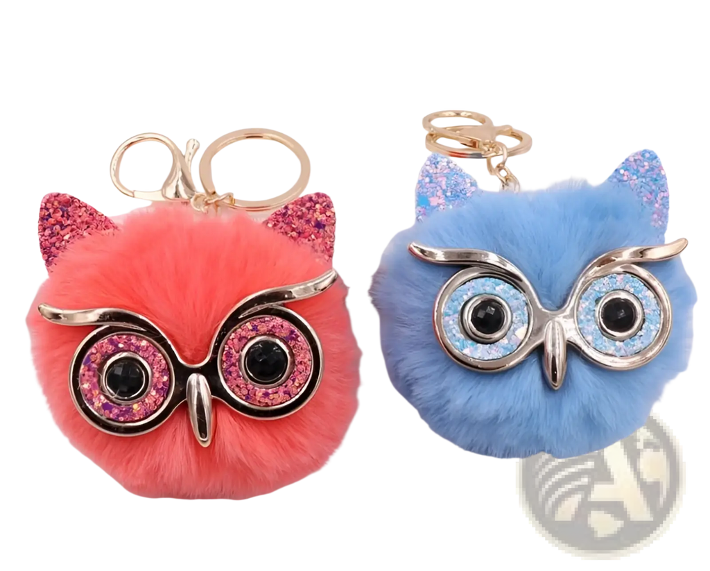 Cute plush owl keychains in vibrant pink and blue with fluffy faux fur, glittery ears, and gold metal hardware