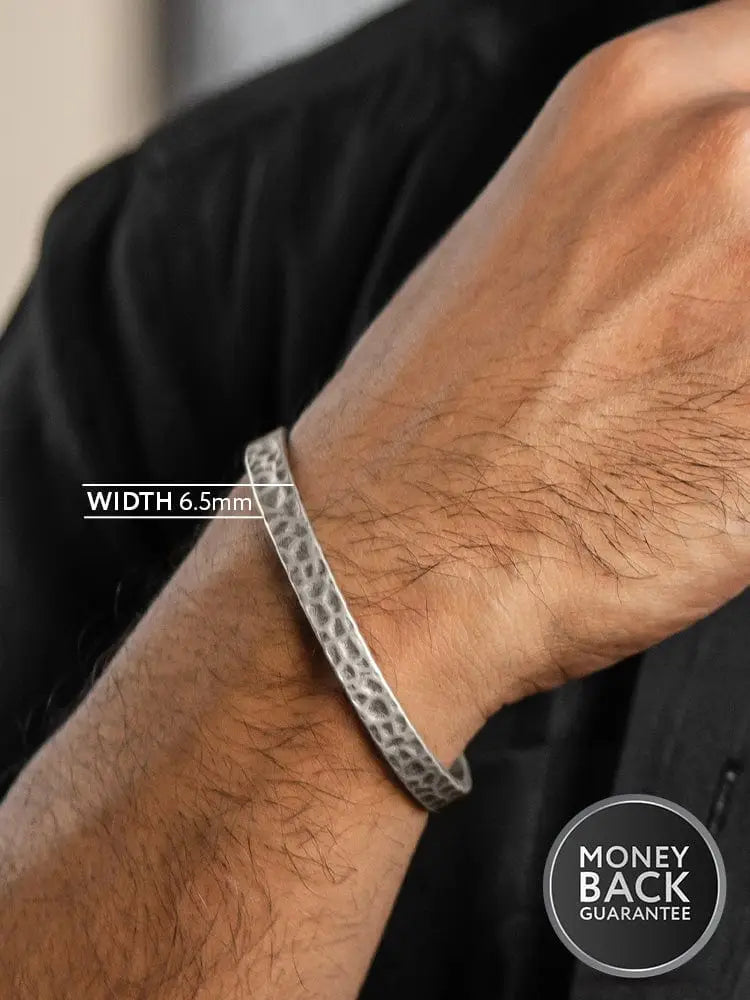 Oxidized hammered silver stainless steel cuff bracelet with silver-toned hammered texture and subtle irregular pattern