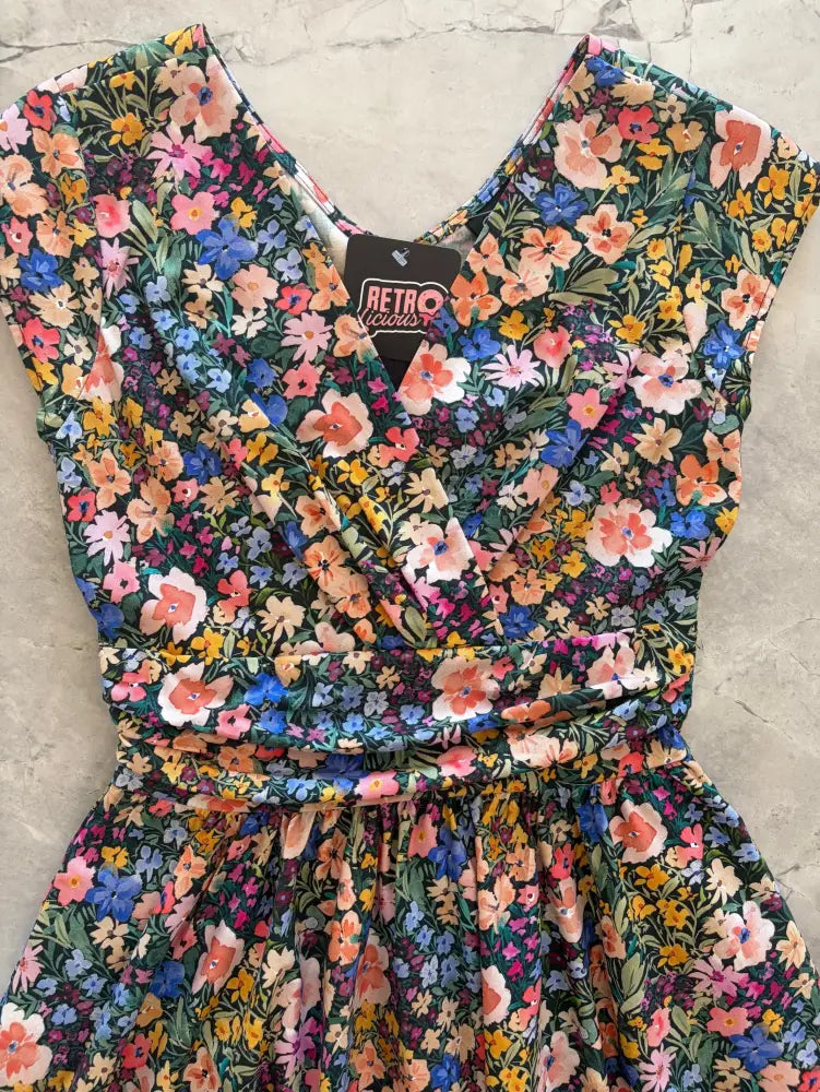 Painted Floral Greta cotton V neck midi dress with pockets featuring a vibrant floral print on dark green base