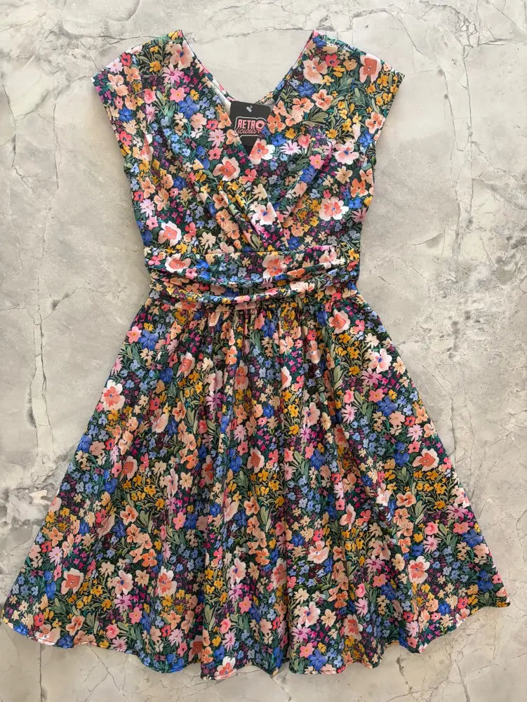 Painted floral greta cotton v neck midi dress with pockets featuring a dark green base and vibrant floral print