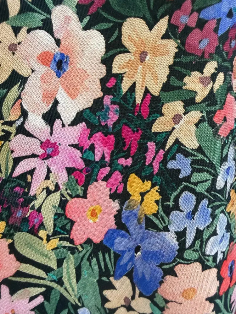 Painted floral greta cotton v neck midi dress with pockets featuring vibrant multicolor floral pattern on dark green background