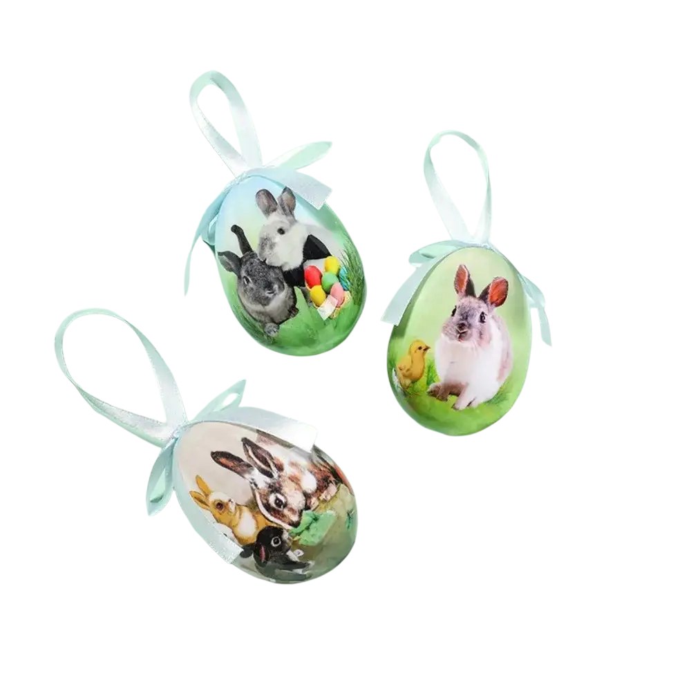 Three painted foam easter eggs hanging ornaments with colorful bunny illustrations and light blue ribbons on glossy surface