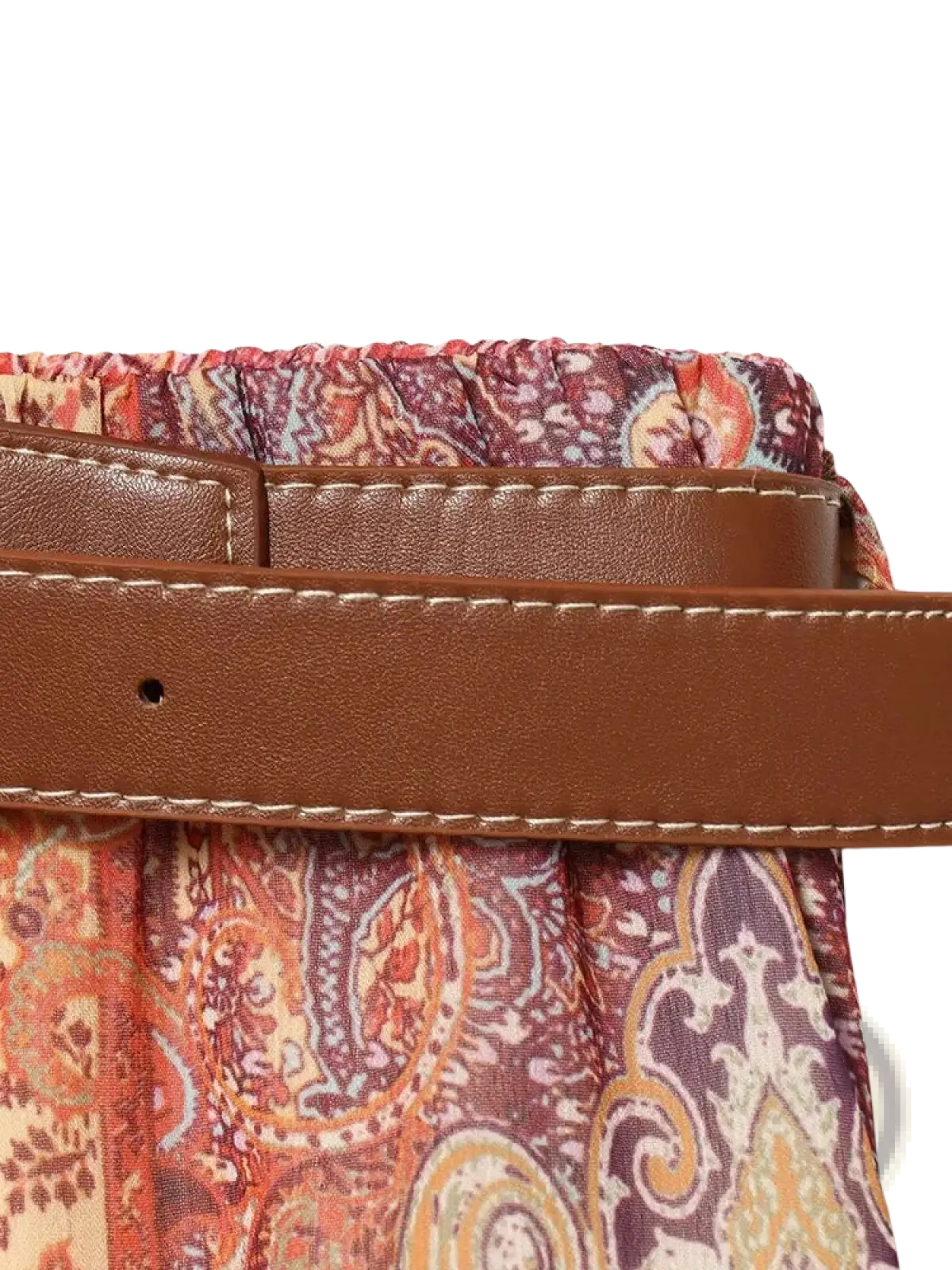 Brown leather belt with white stitching worn over paisley print high waist midi skirt fabric