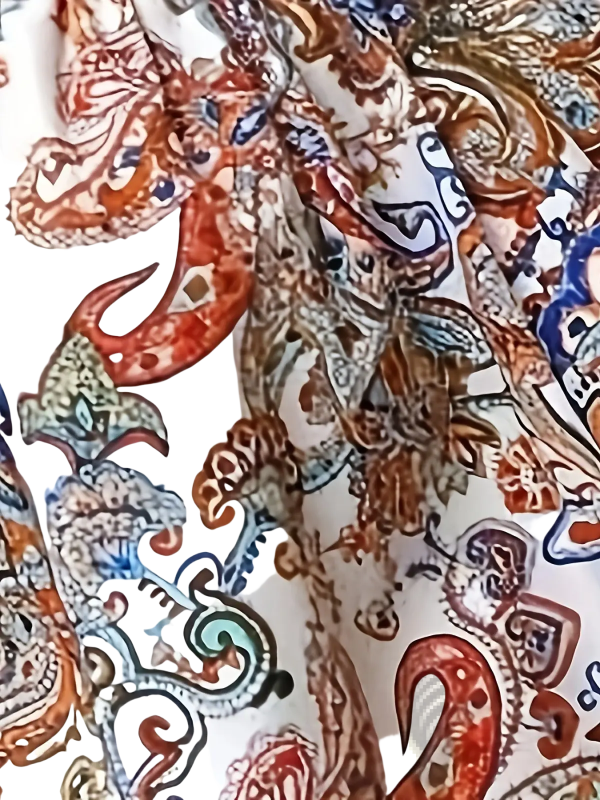 Paisley print spaghetti strap top with vibrant rust teal and navy paisley pattern on white fabric for casual wear