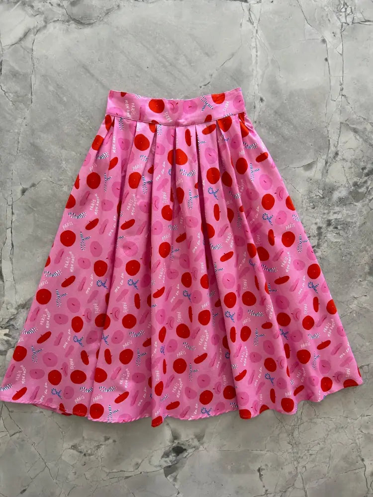 Paris Doris pink retro pleated cotton skirt with pockets featuring a playful red and pink donut pattern on lightweight fabric