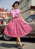 Pink retro pleated cotton skirt with pockets featuring polka dots and orange and blue ribbon patterns by paris doris