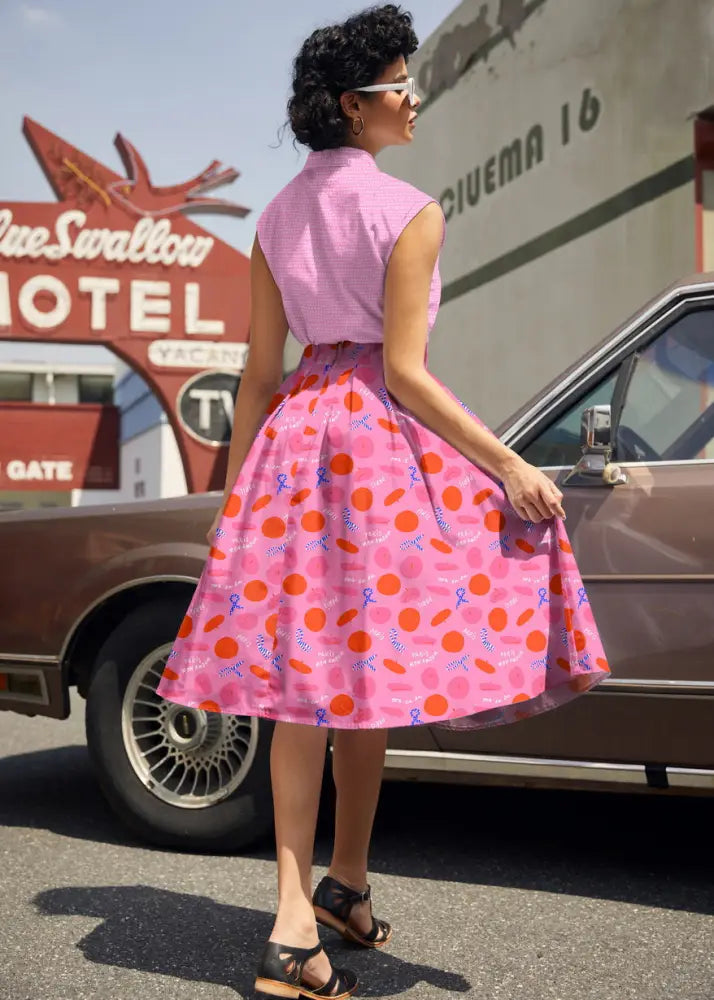 Paris Doris pink retro pleated cotton skirt with pockets featuring orange polka dots and blue ribbon motifs