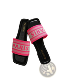 Black slide sandals with vibrant pink and white striped strap featuring paris lettering for casual wear