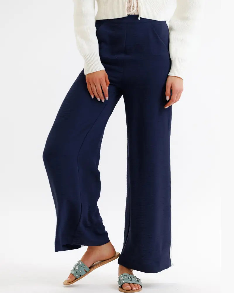 Parisian high waist navy wide leg pleated trousers in smooth flowing fabric with subtle side slits