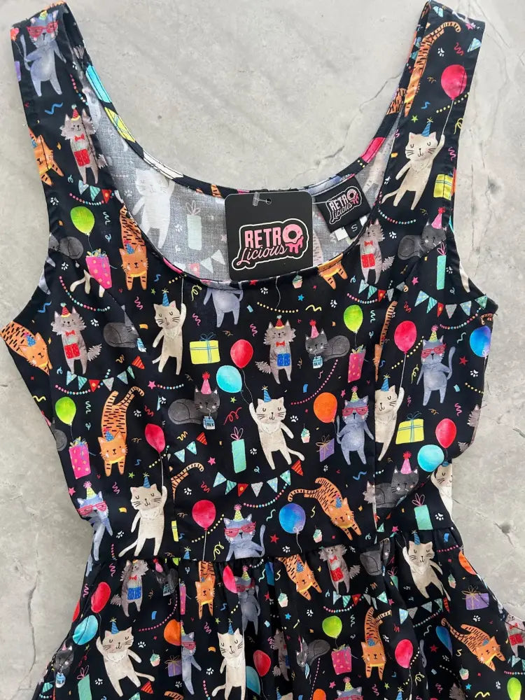 Black sleeveless party cats retro fit and flare cotton dress with pockets featuring cartoon cats balloons and gifts pattern