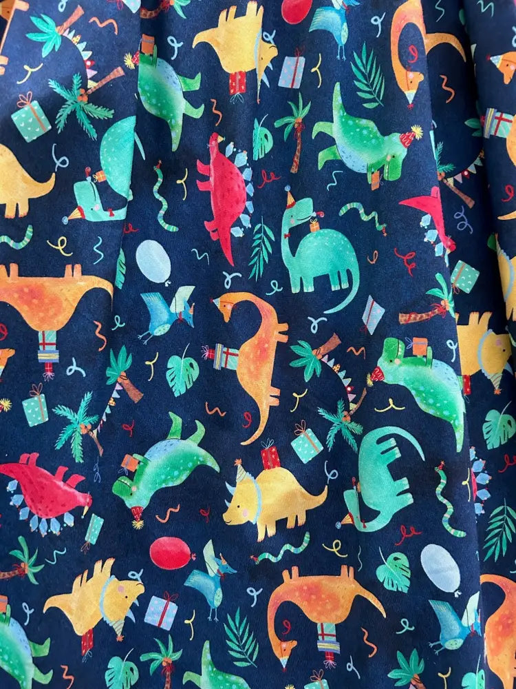 Vintage party dinos navy cotton sleeveless dress with vibrant dark blue fabric and colorful cartoon dinosaur party pattern