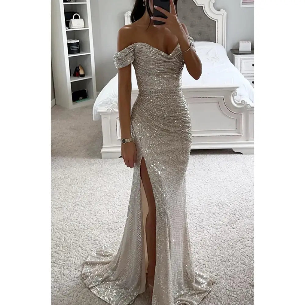 Off the shoulder silver sequin mermaid gown with high slit and fitted silhouette for elegant occasions