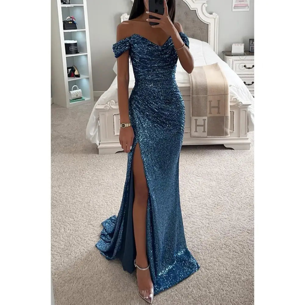 A shimmering royal blue sequined off the shoulder evening gown with a high slit and fitted mermaid silhouette