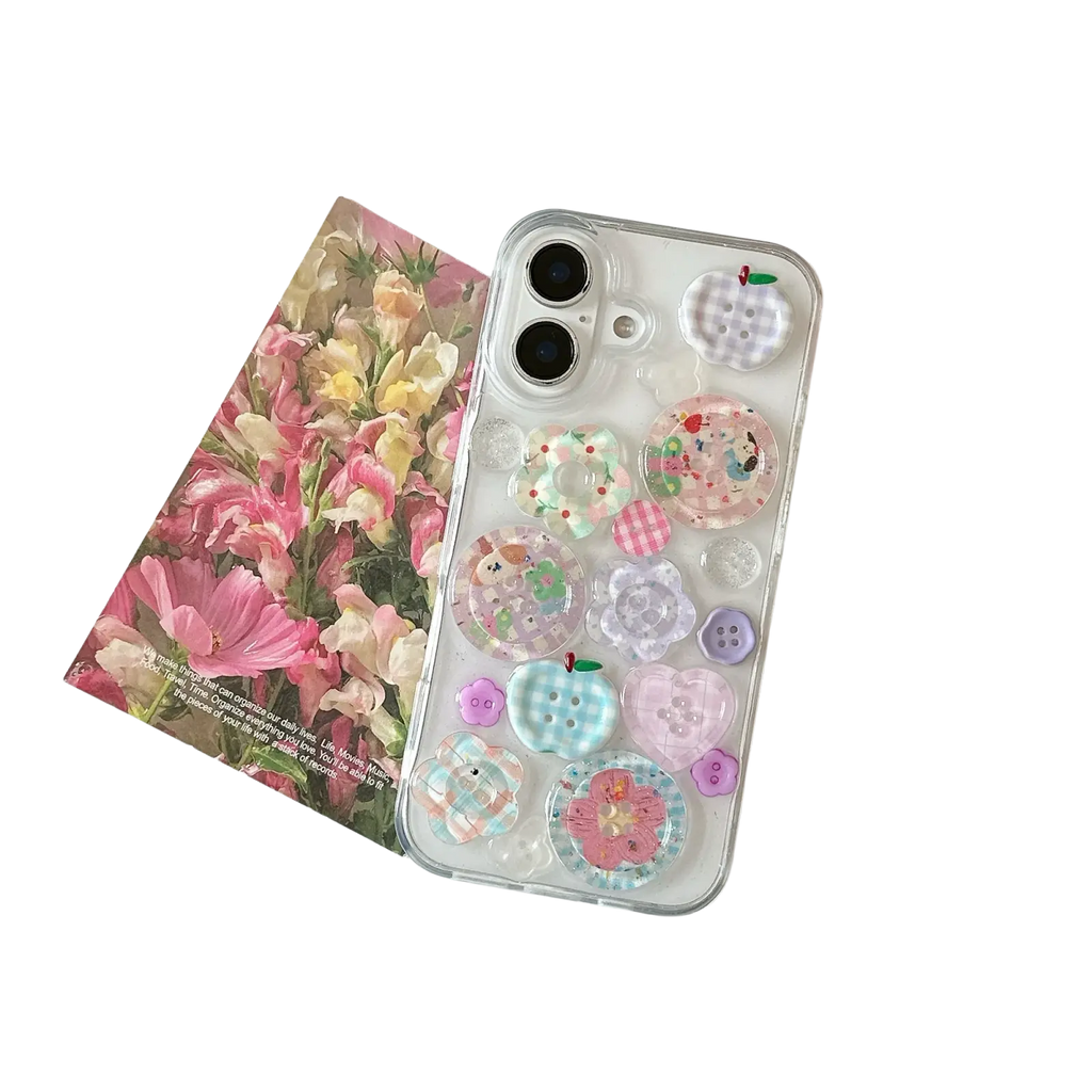 Pastel button clear iphone case showing back with colorful translucent button and flower-shaped charms in pastel shades