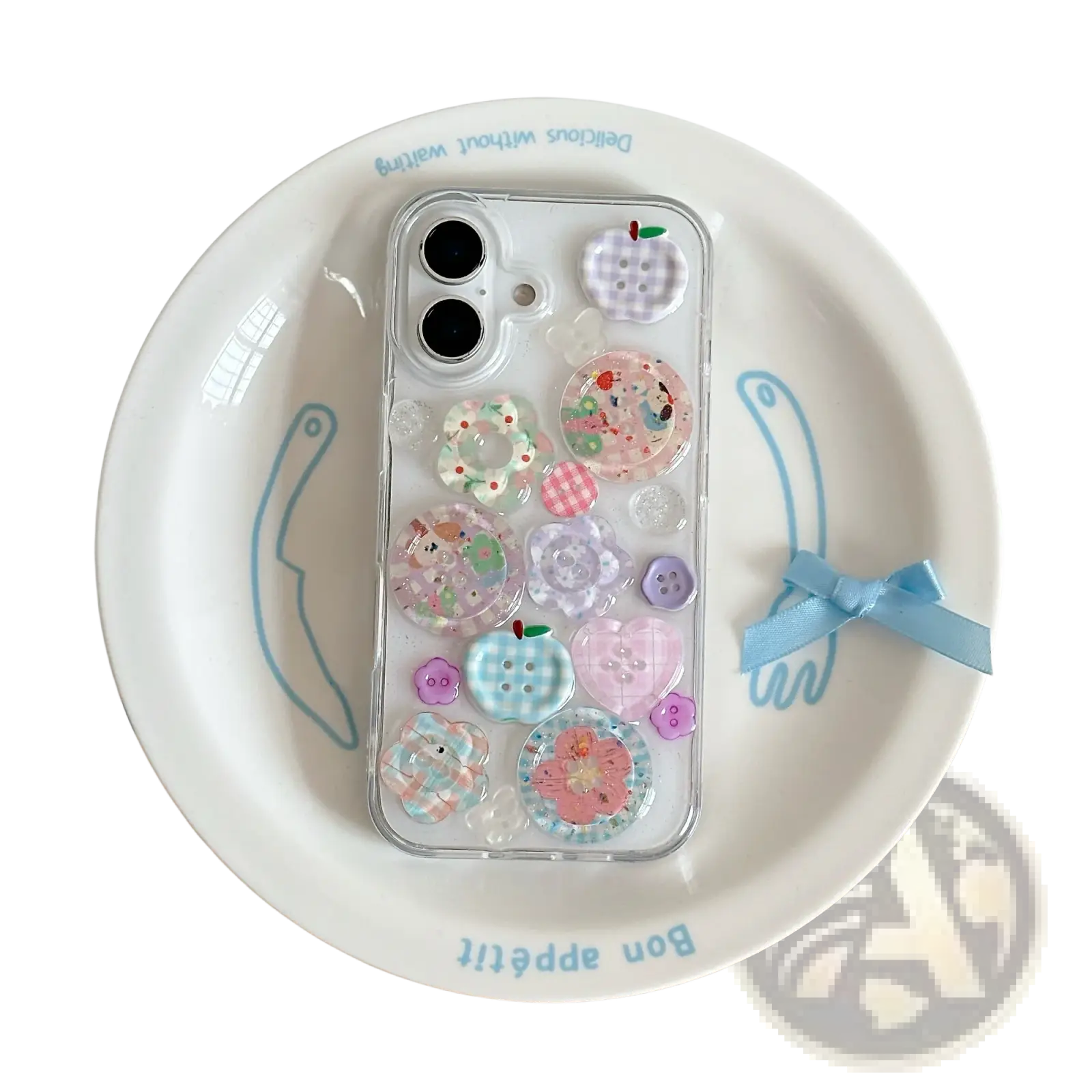 A clear iphone case decorated with pastel pink blue and purple decorative buttons shown from the back side
