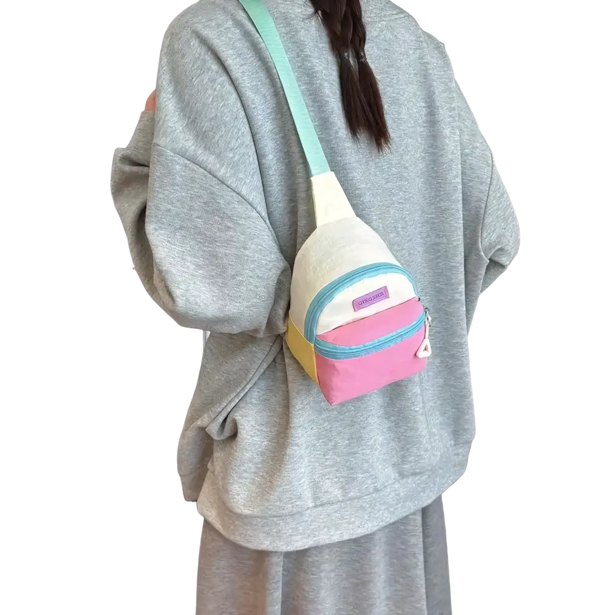 Pastel kids crossbody bag with lightweight canvas material, featuring mint green strap and pink yellow white panels
