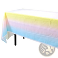 Pastel rainbow party tableware set featuring a smooth translucent plastic tablecloth with yellow pink and blue gradient