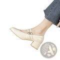 Cream-colored patent leather mary jane double strap block heels with two silver buckle straps for stylish wear