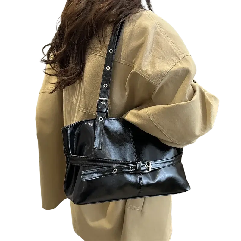 Black patent leather shoulder bag with silver buckle and adjustable shoulder strap details