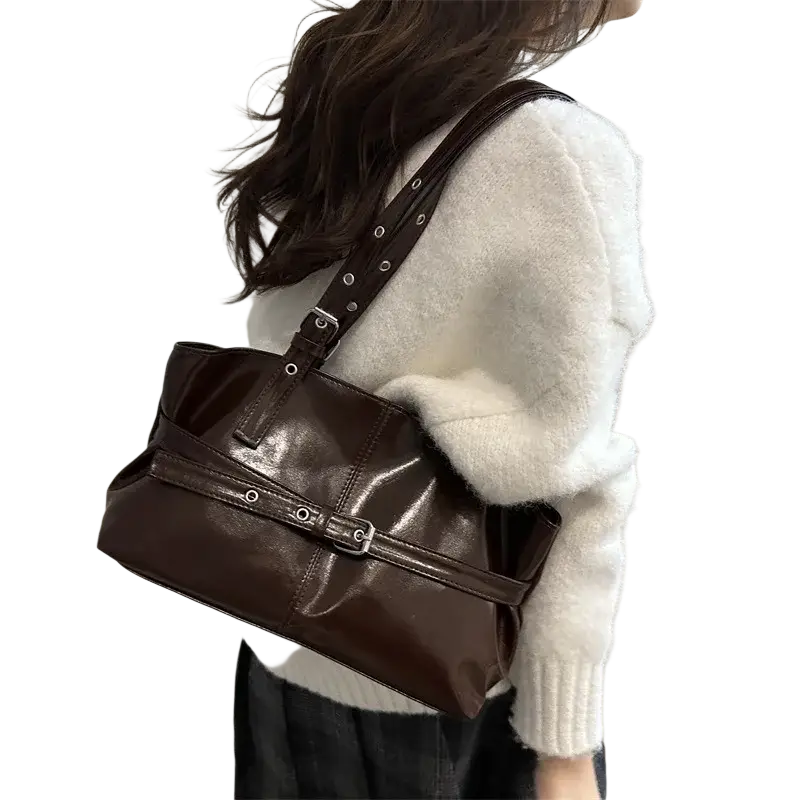 Brown patent leather shoulder bag with adjustable shoulder strap and silver-toned metal hardware accents