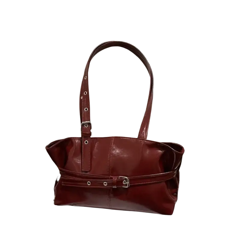 Glossy burgundy patent leather shoulder bag with adjustable shoulder strap and silver-toned hardware in structured shape