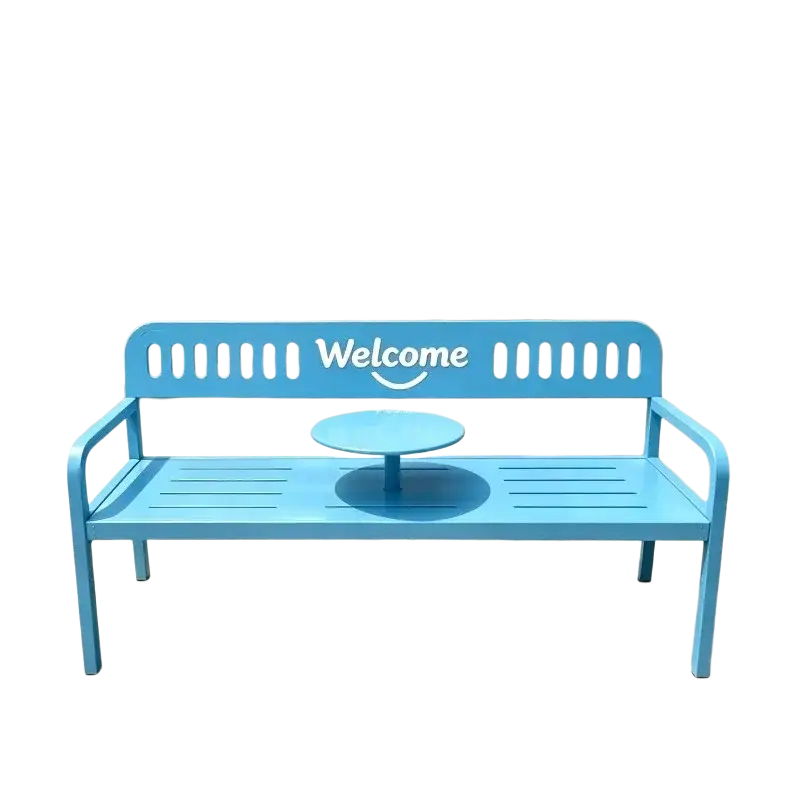 Bright blue metal patio benches with welcome sign on backrest and a small round table as outdoor furniture set