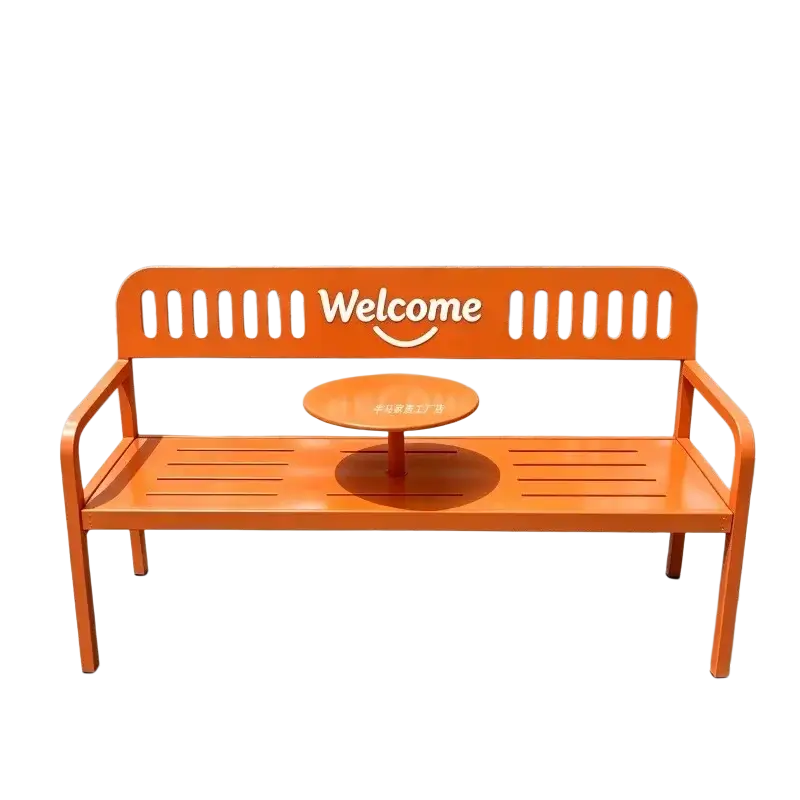 Bright orange metal patio bench with welcome sign and small round center table for outdoor furniture use