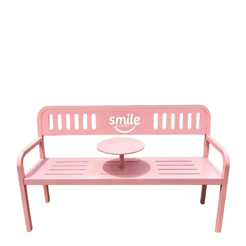Pink metal patio bench with built-in circular table and smile logo on backrest for outdoor furniture use