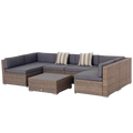Gray cushioned outdoor wicker sectional sofa with striped pillows and coffee table in a 7 piece patio furniture set