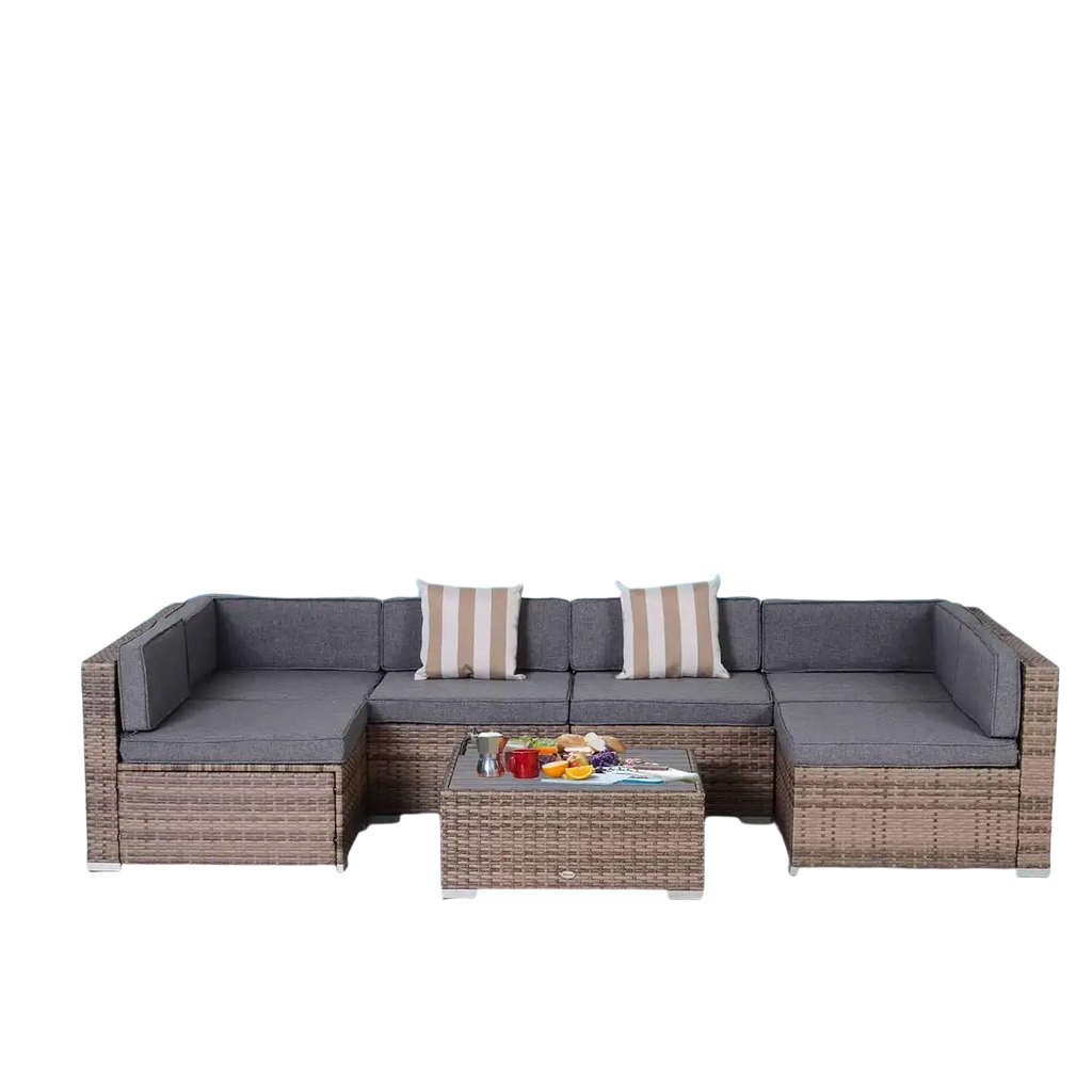 Gray woven wicker outdoor furniture set featuring a 7 piece sectional and coffee table with striped accent pillows
