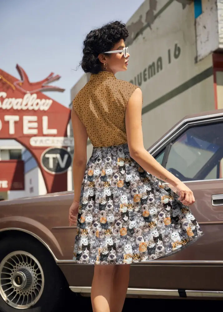 Vintage paw print bow sleeveless cotton a-line dress with brown polka-dot top and multicolor cat face skirt pattern