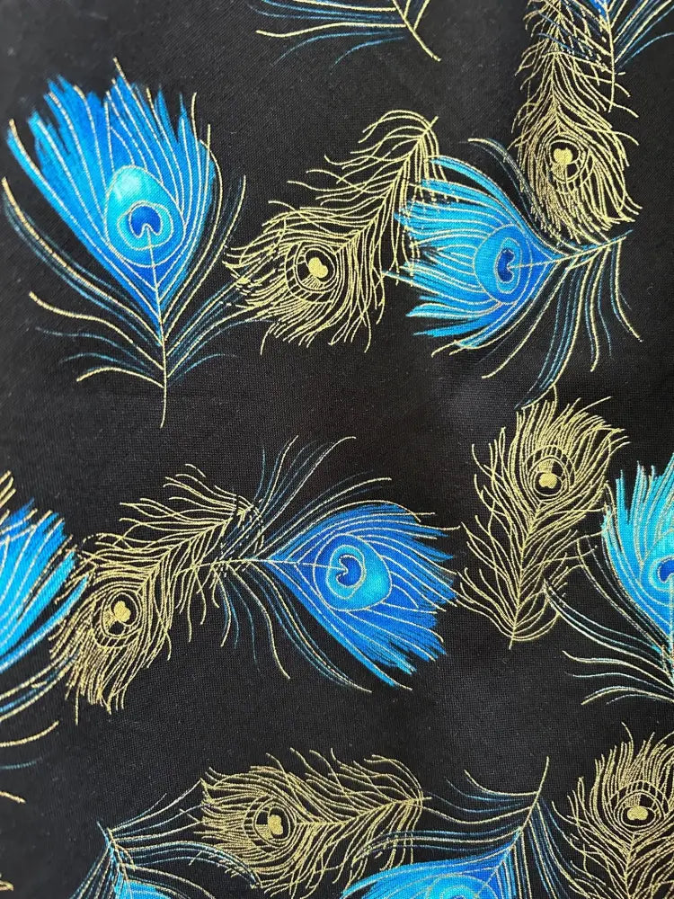 Black cotton fabric of vintage peacock feather sleeveless A-line dress with vibrant blue and gold feather pattern