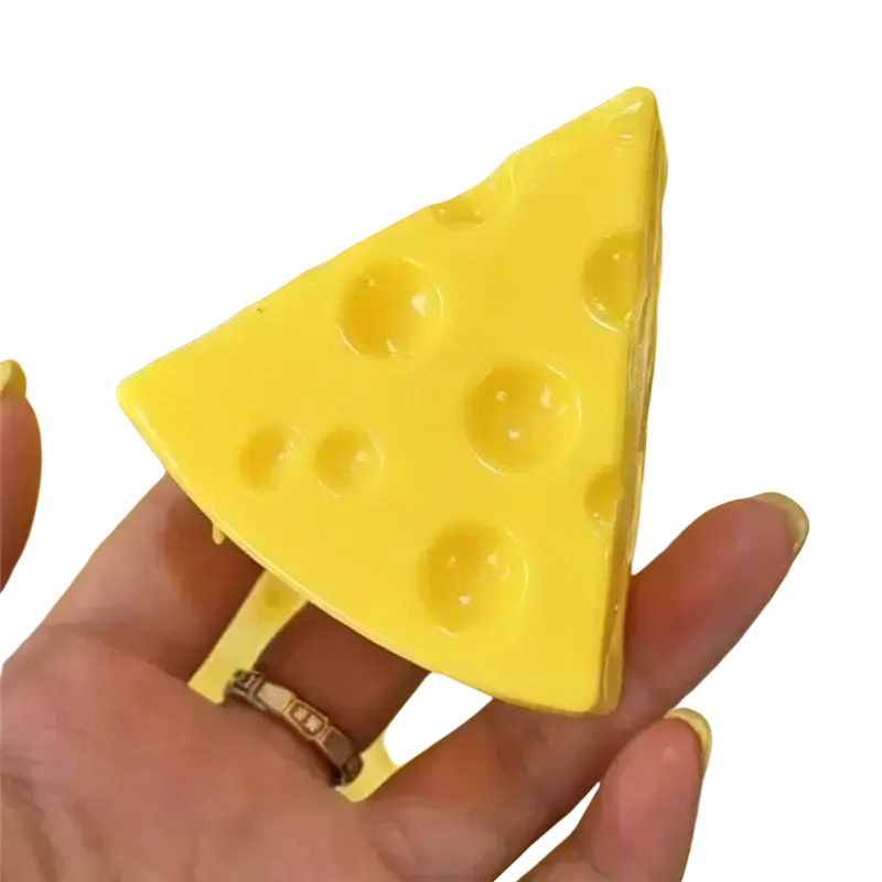 A bright yellow triangular cheese-shaped peanut stress ball sensory fidget toy with molded holes