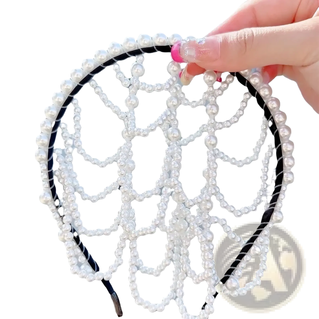 A delicate white pearl bridal crown hair band with a black elastic band and intricate beaded tassel design