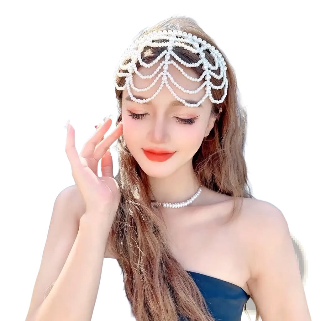 A delicate white pearl bridal crown hair band with an intricate cascading chandelier tassel design